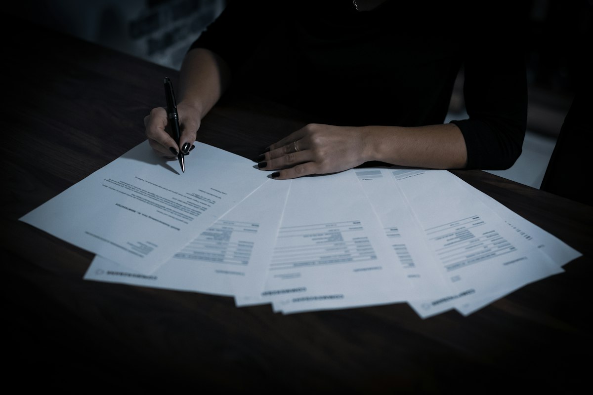 An elderly person's hands resting on documents